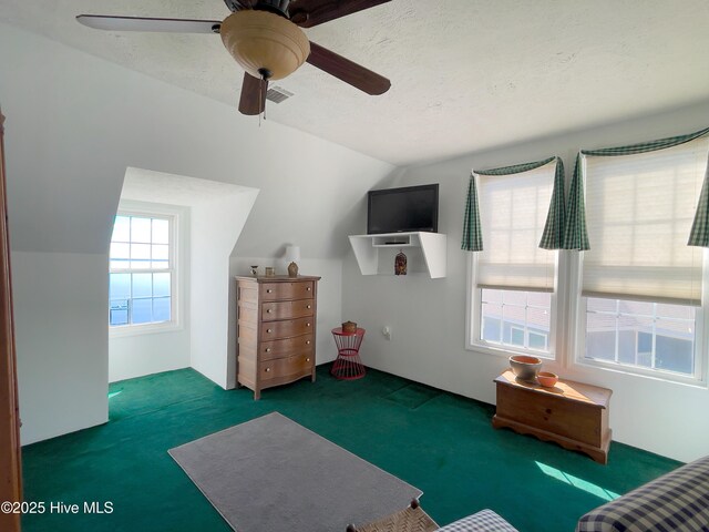 sitting room featuring visible vents, a textured ceiling, carpet flooring, lofted ceiling, and ceiling fan