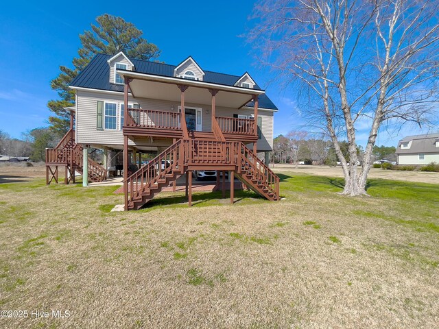 wooden deck with a yard and a water view