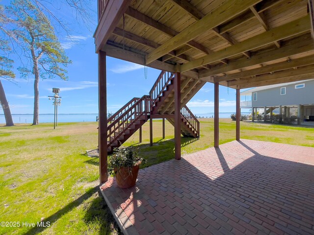 exterior space with metal roof, a carport, and a front yard