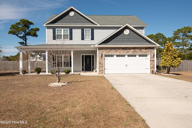 view of front of property featuring a porch, a garage, fence, stone siding, and driveway