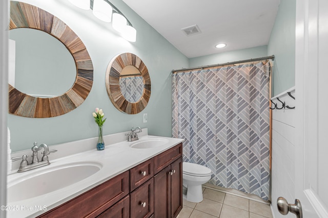 bathroom with toilet, tile patterned flooring, visible vents, and a sink