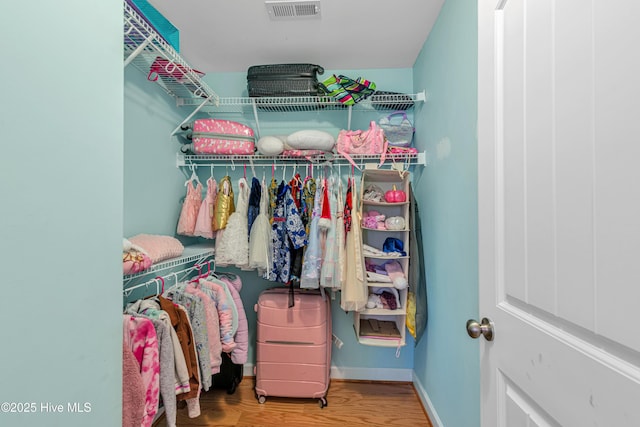 spacious closet featuring visible vents and wood finished floors