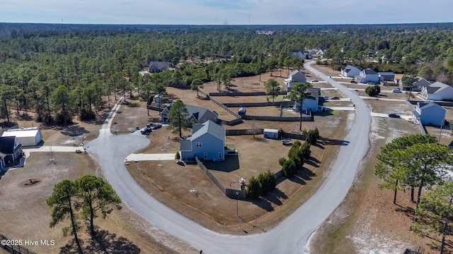 birds eye view of property with a wooded view