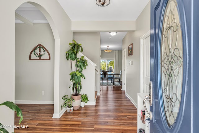 foyer entrance with baseboards and wood finished floors