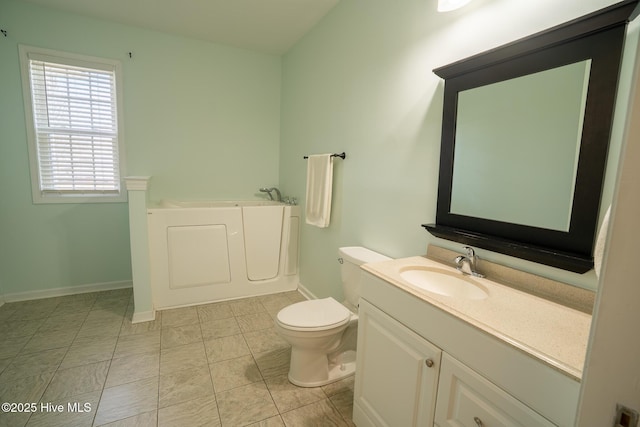 full bathroom featuring vanity, a garden tub, toilet, and baseboards