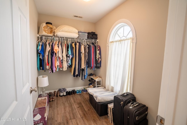 walk in closet with wood finished floors and visible vents