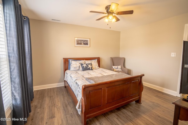 bedroom featuring visible vents, baseboards, and dark wood-style flooring