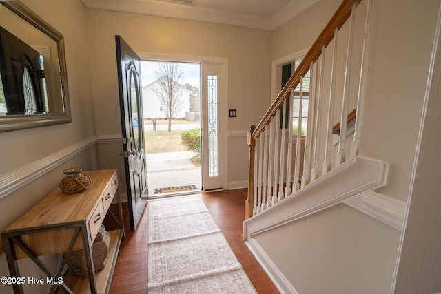 entryway featuring stairs, wood finished floors, and crown molding