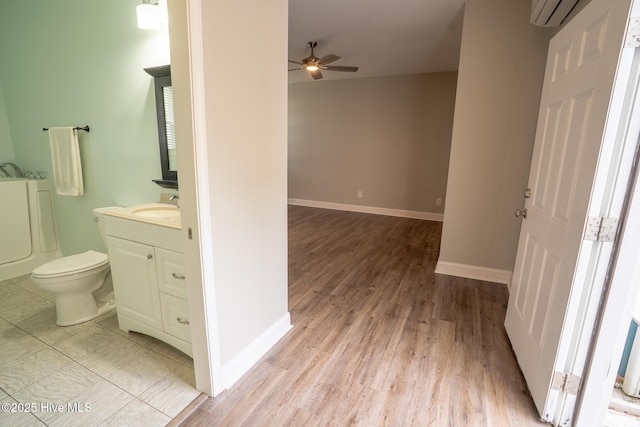 full bath featuring toilet, a ceiling fan, vanity, and baseboards