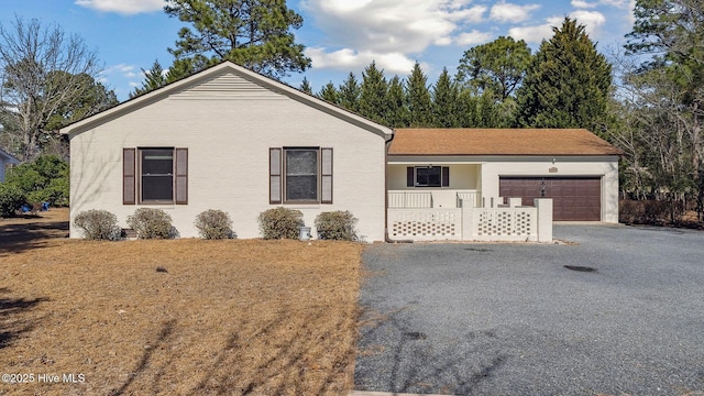 single story home featuring driveway and an attached garage