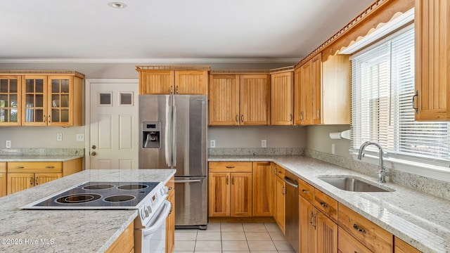 kitchen featuring appliances with stainless steel finishes, ornamental molding, light stone countertops, a sink, and light tile patterned flooring