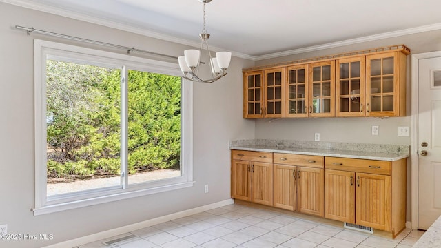 kitchen featuring glass insert cabinets, visible vents, crown molding, and light stone counters