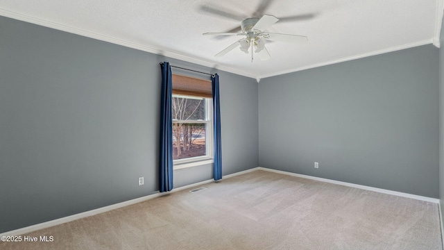 carpeted spare room with ceiling fan, a textured ceiling, baseboards, and crown molding