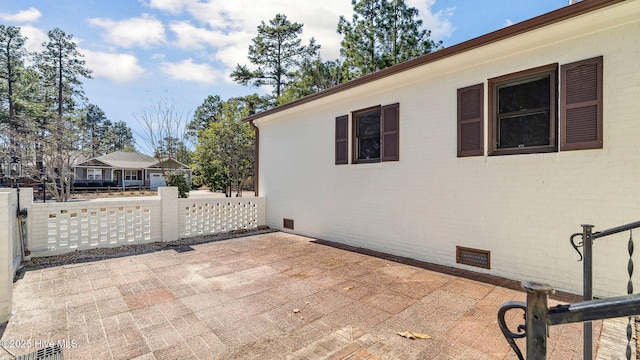 view of patio with visible vents and fence