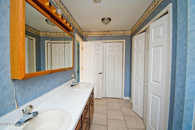 full bath with a closet, tile patterned flooring, and a sink