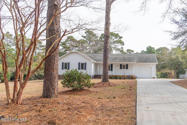 ranch-style house with concrete driveway and a garage