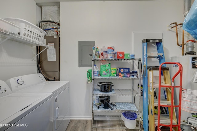 laundry area with laundry area, electric panel, wood finished floors, water heater, and separate washer and dryer