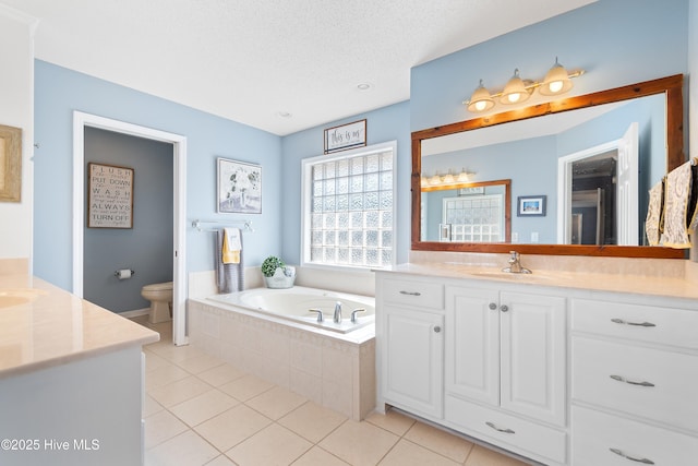 full bath with toilet, tile patterned floors, a textured ceiling, vanity, and a bath