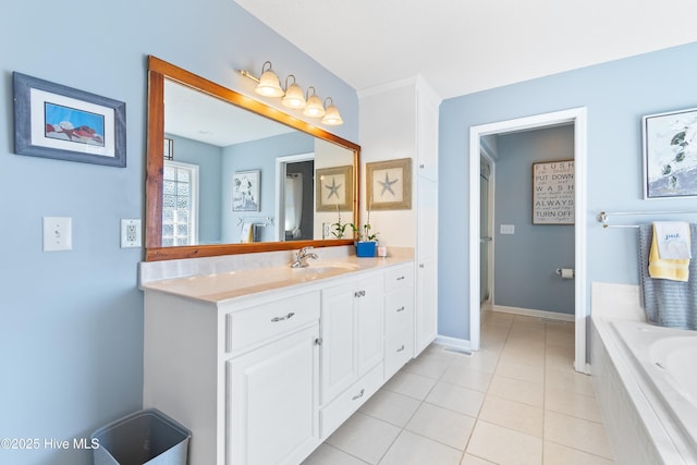 full bathroom featuring a bath, baseboards, vanity, and tile patterned floors