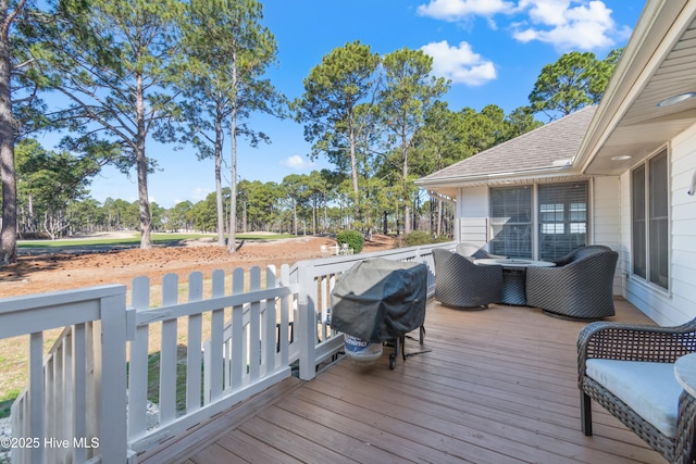 wooden deck featuring a grill