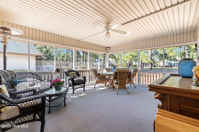 sunroom featuring ceiling fan