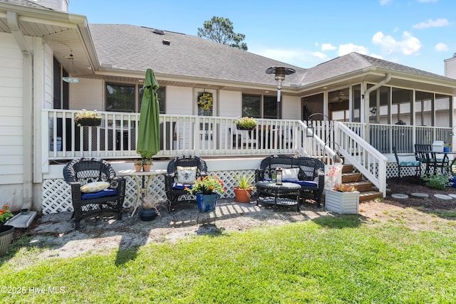 back of house featuring a sunroom and a shingled roof