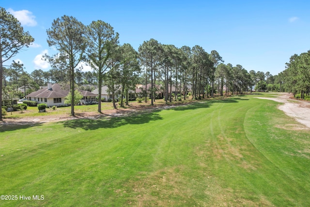 view of property's community with a lawn