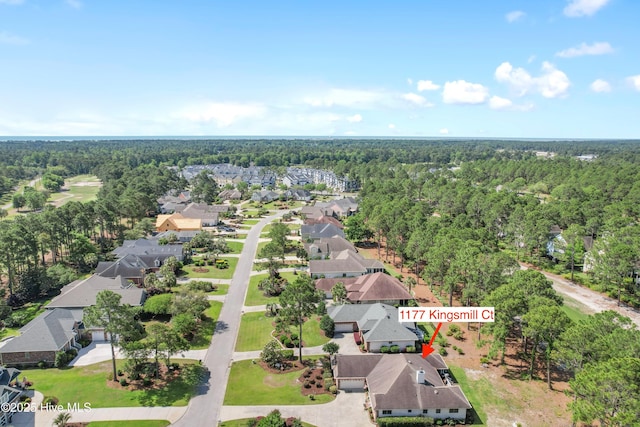 birds eye view of property featuring a residential view and a wooded view