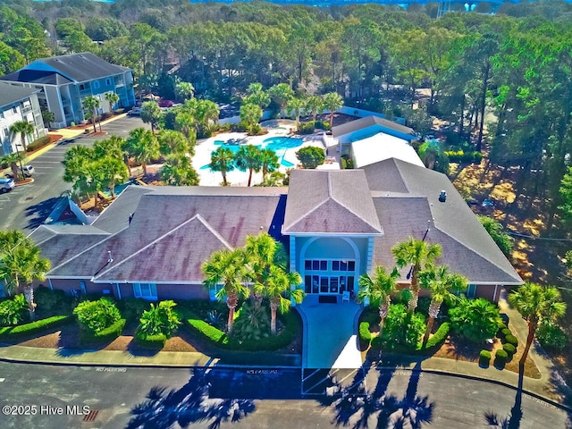 drone / aerial view featuring a wooded view