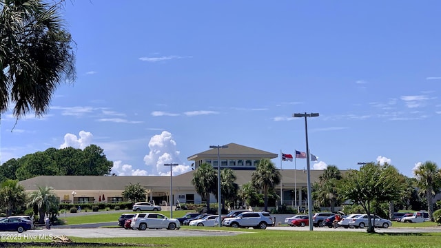 view of building exterior with uncovered parking