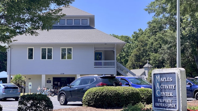 view of front of house featuring a garage and roof with shingles