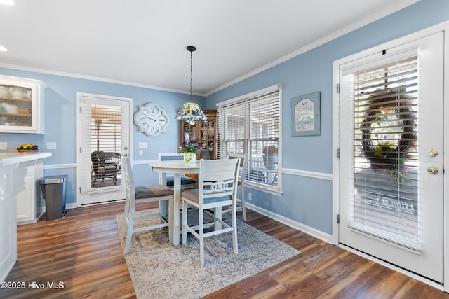 dining area with ornamental molding, dark wood-type flooring, and baseboards