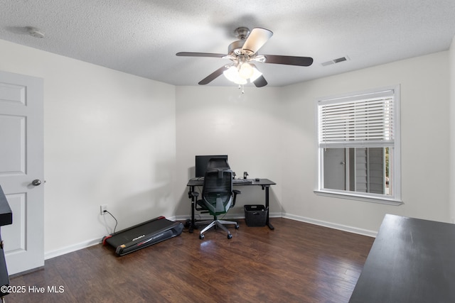 office space with baseboards, visible vents, ceiling fan, wood finished floors, and a textured ceiling