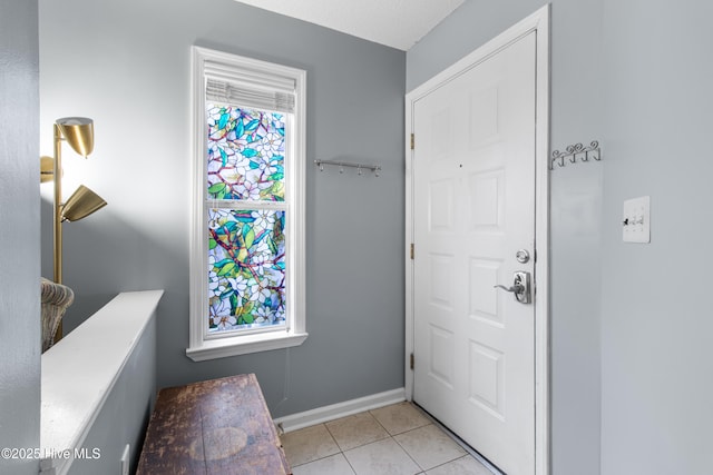 entrance foyer with baseboards and light tile patterned flooring