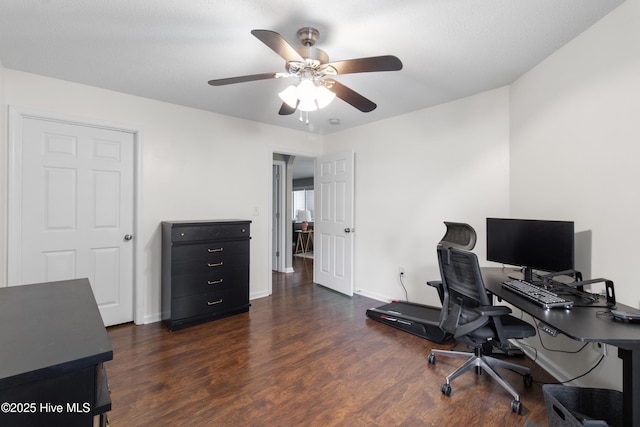 office area with dark wood finished floors, baseboards, and ceiling fan