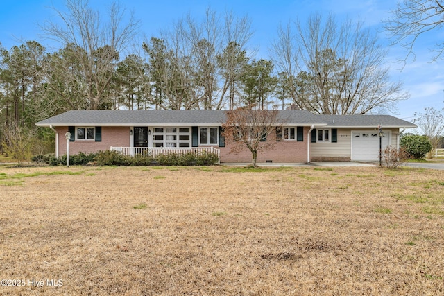 ranch-style home featuring a porch, a front yard, an attached garage, crawl space, and brick siding