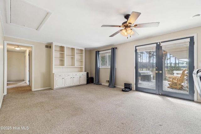 unfurnished living room featuring visible vents, baseboards, attic access, light carpet, and a ceiling fan