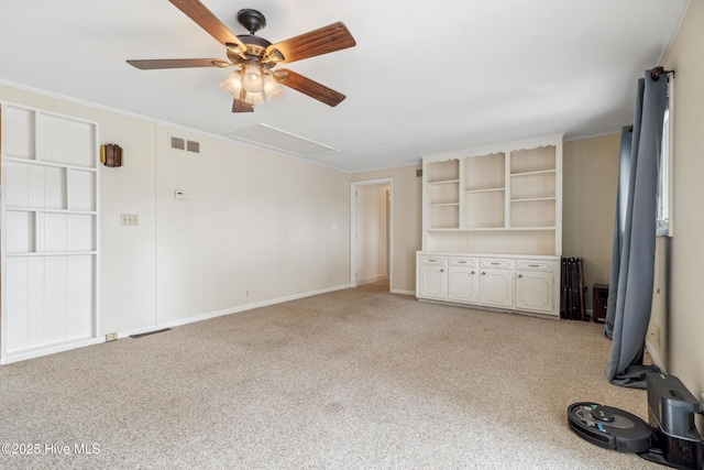 unfurnished living room featuring visible vents, light colored carpet, ornamental molding, and a ceiling fan