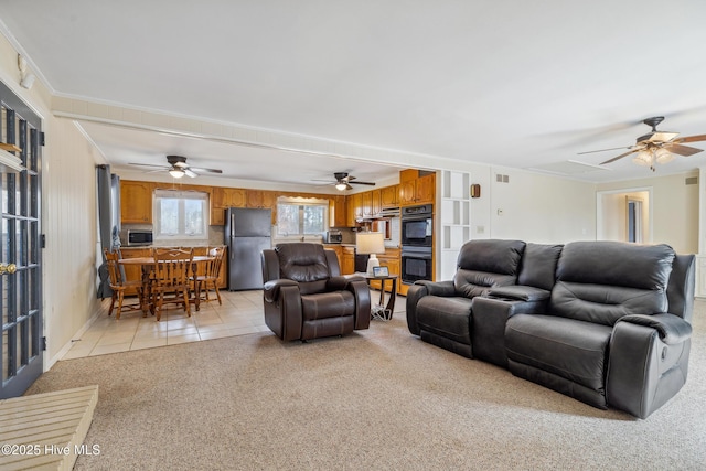 living room featuring light tile patterned floors, visible vents, and light carpet