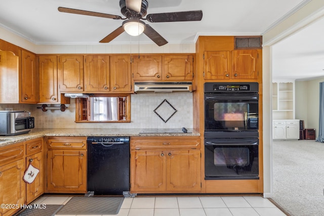 kitchen with visible vents, black appliances, under cabinet range hood, brown cabinetry, and light colored carpet