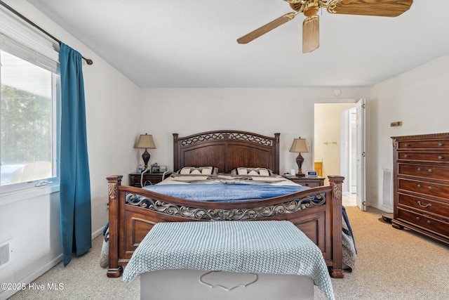 bedroom with visible vents, multiple windows, and light colored carpet