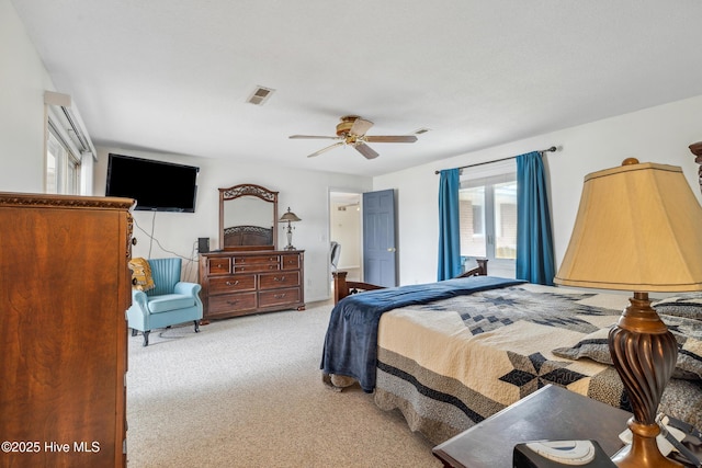 carpeted bedroom with visible vents and ceiling fan