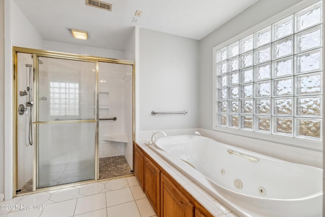 full bathroom featuring tile patterned floors, visible vents, a shower stall, and a tub with jets