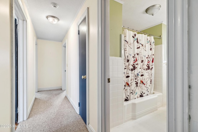 corridor with carpet floors and a textured ceiling