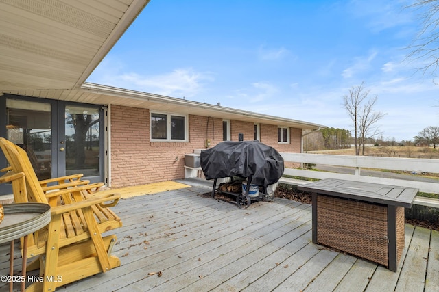 wooden terrace featuring area for grilling