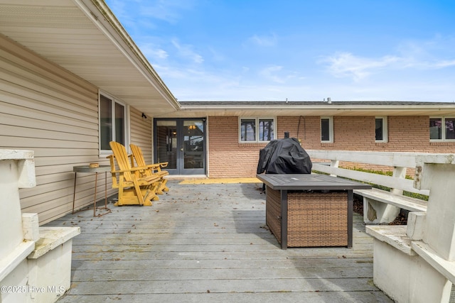 wooden deck with french doors and area for grilling