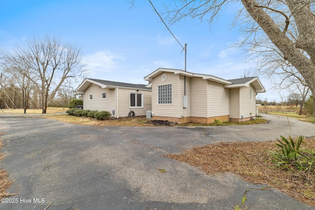 view of side of home featuring driveway