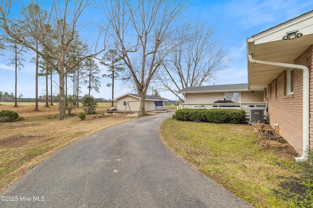 view of front of house featuring a front lawn and central air condition unit