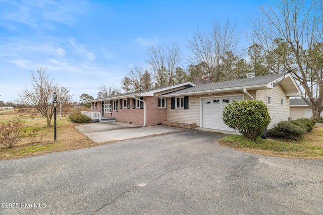 single story home featuring aphalt driveway, roof with shingles, an attached garage, brick siding, and a chimney