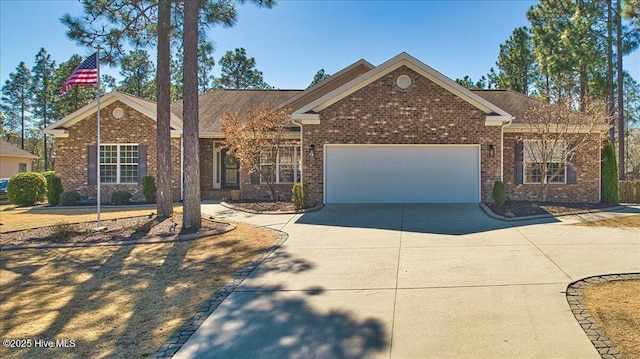 view of front of house featuring a garage, brick siding, and concrete driveway